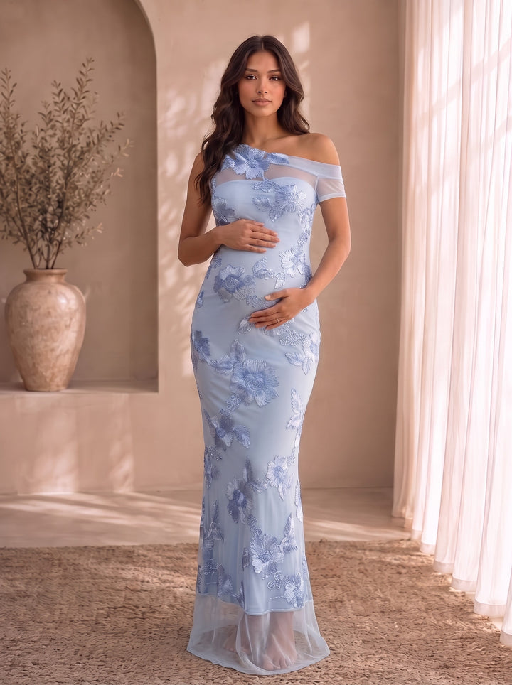 Estelle blue one-shoulder maternity maxi dress with floral embroidery on sheer mesh, front view