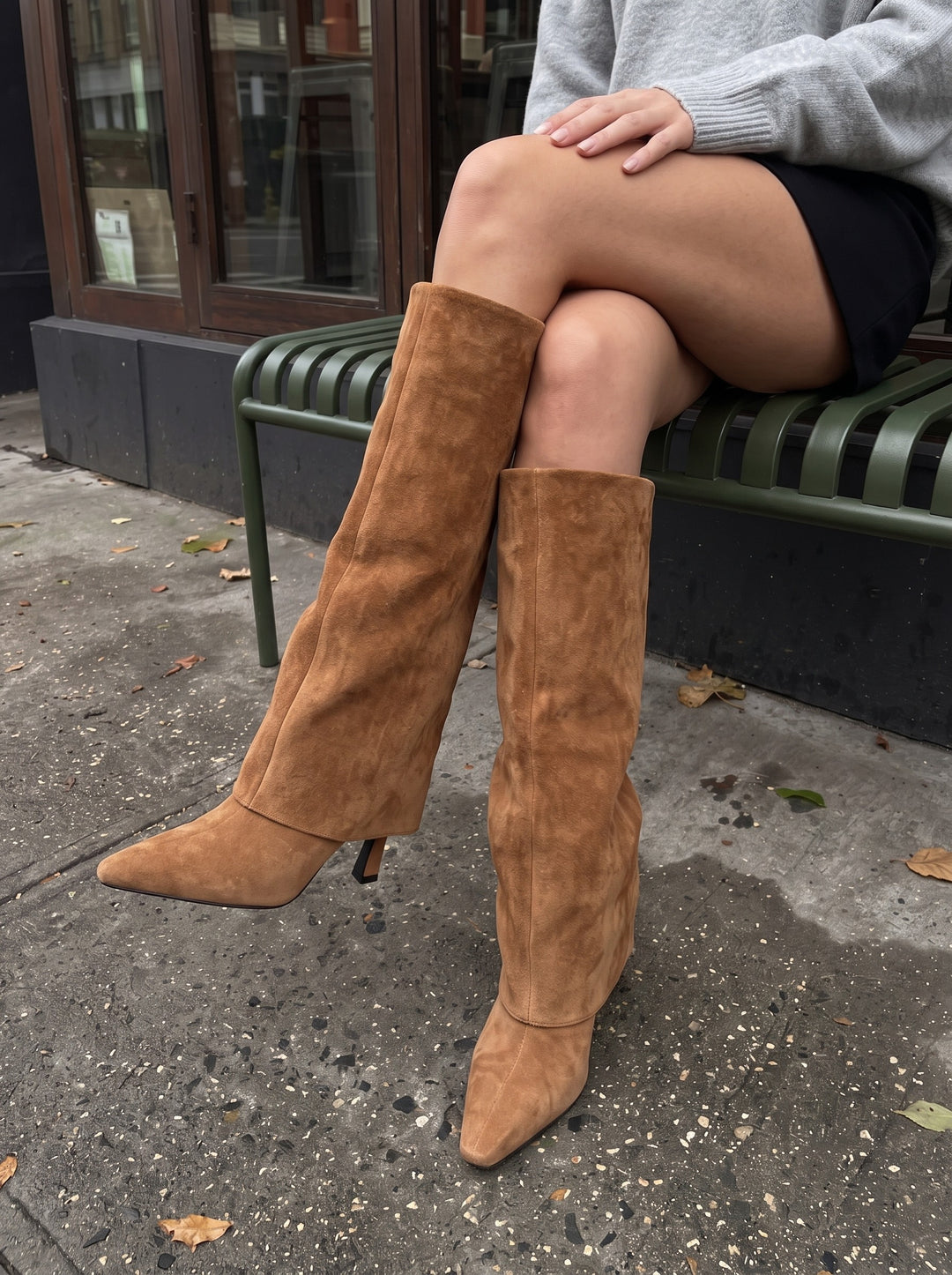 Ila brown suede boots close-up showing the fold-over shaft, pointed toe and slim heel