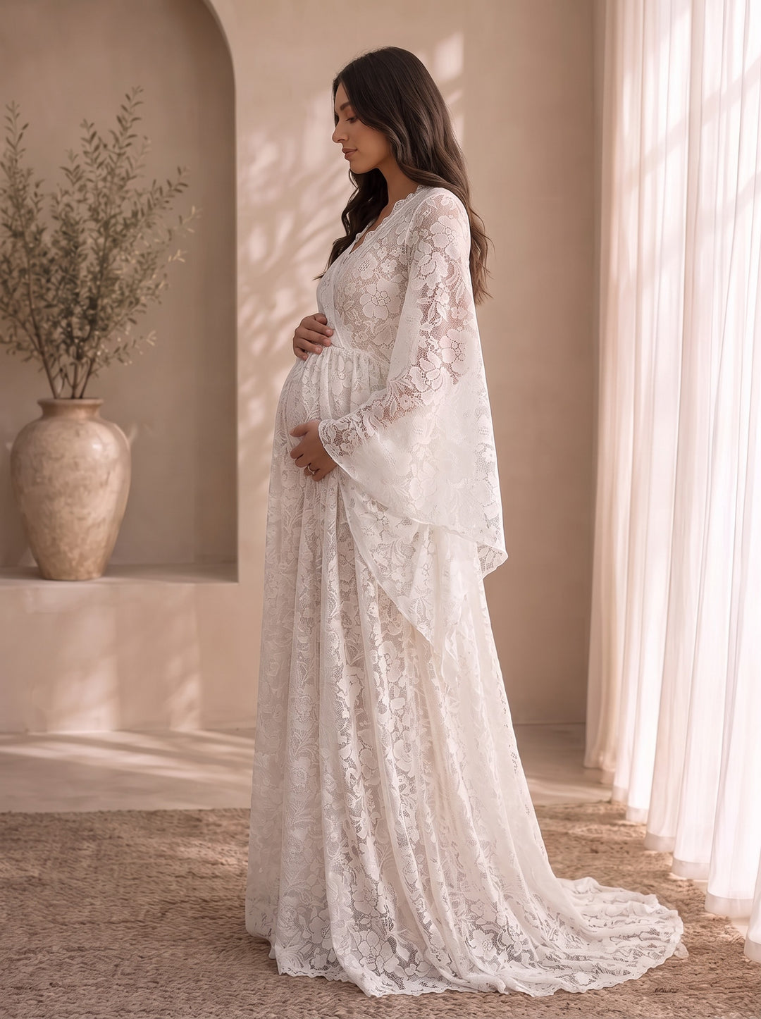 Mariposa lace maternity gown, side profile showing the empire waist and the skirt flowing loosely over the bump