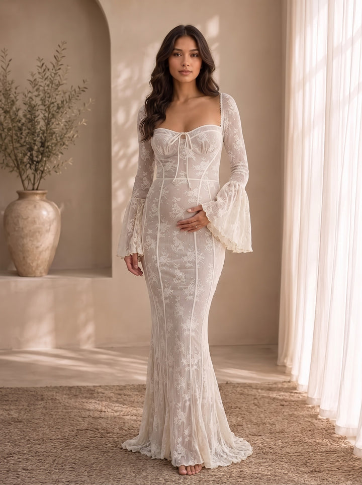 Matilda white lace maternity maxi dress, front view with square neckline, tie at the bust, long bell sleeves and fishtail hem